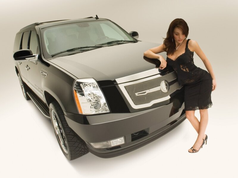 woman in black dress with luxury suv
