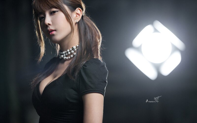 woman in black dress with pearls