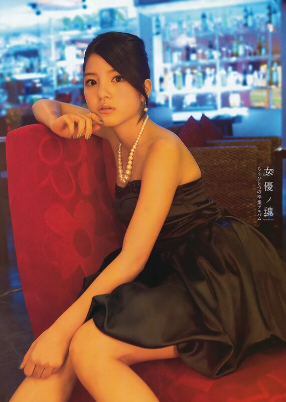 woman in black dress with pearls