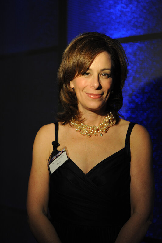 woman in black dress with pearls