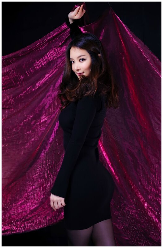 woman in black dress with purple fabric