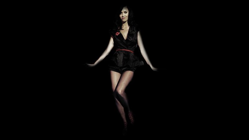 woman in black dress with red poppy