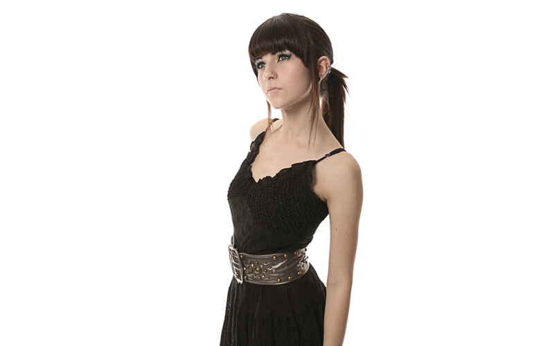 woman in black dress with studded belt