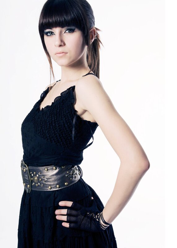 woman in black dress with studded belt