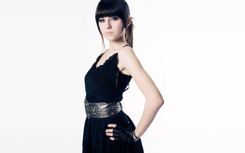 woman in black dress with studded belt