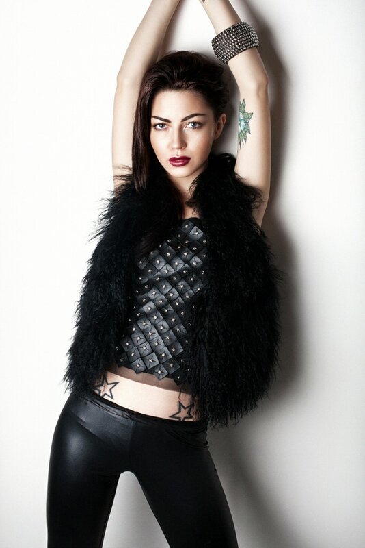 woman in black feather vest