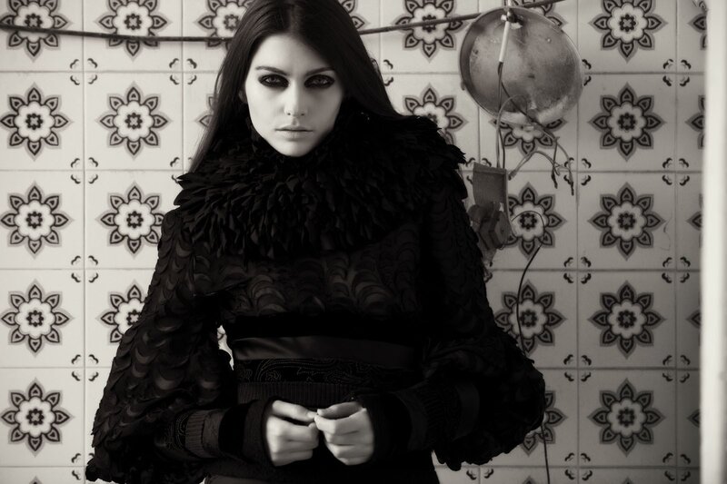 woman in black feathered coat