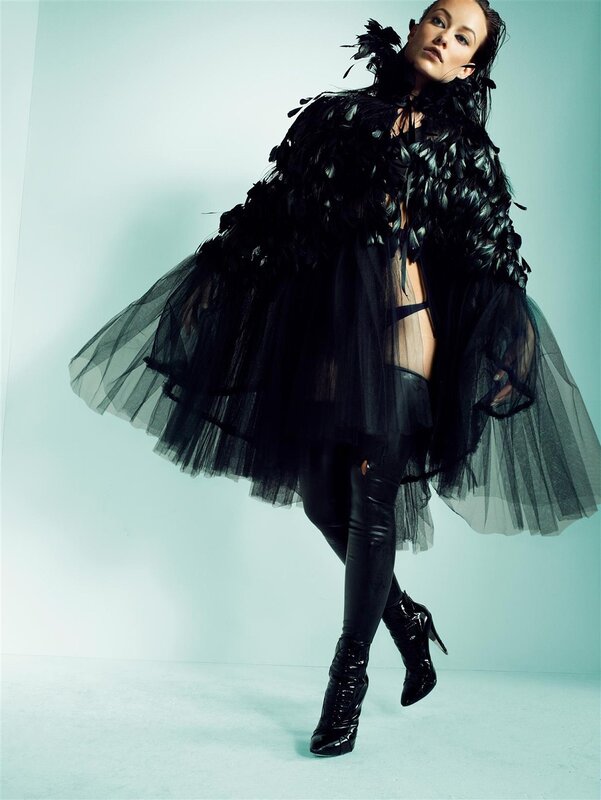 woman in black feathered outfit
