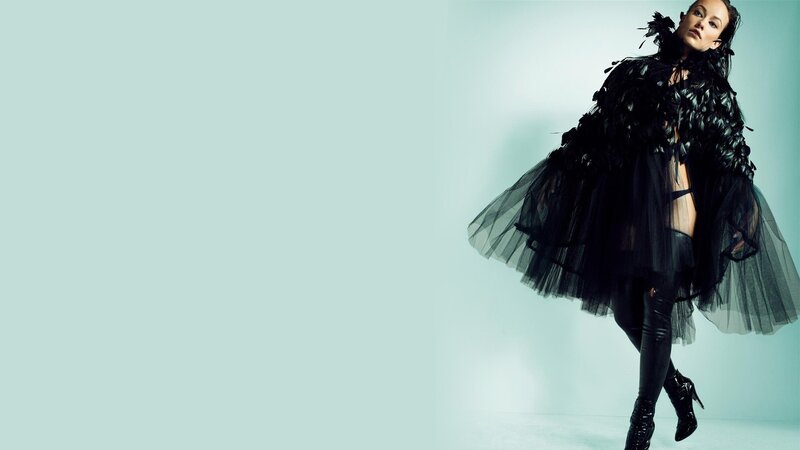 woman in black feathered outfit