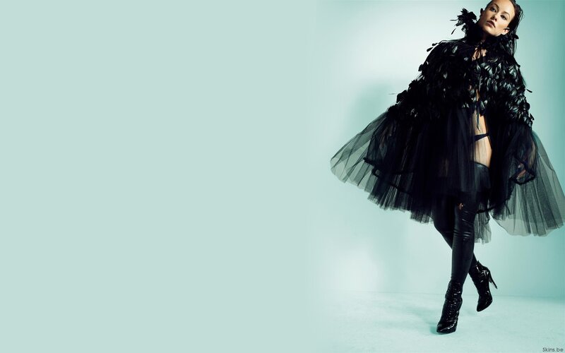 Woman in Black Feathered Outfit — Dramatic