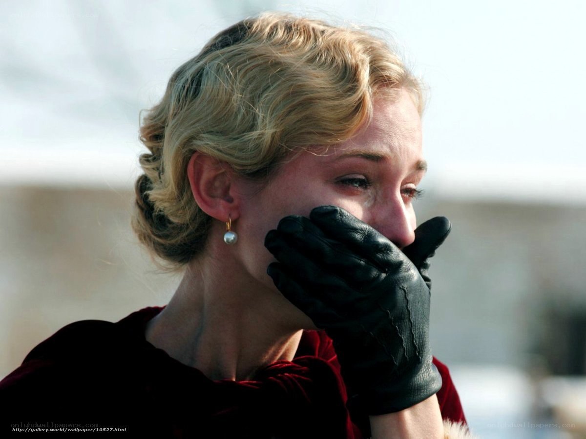 woman in black gloves crying