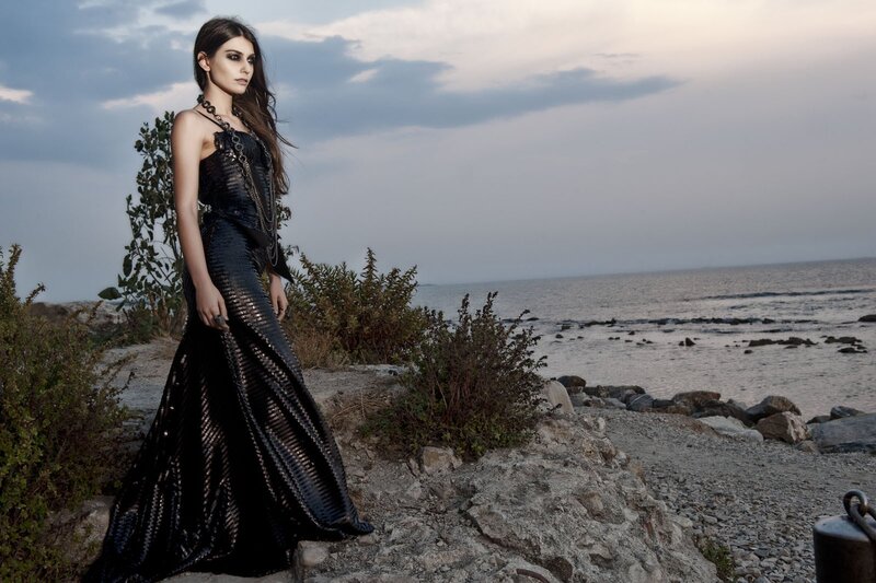 woman in black gown by the sea