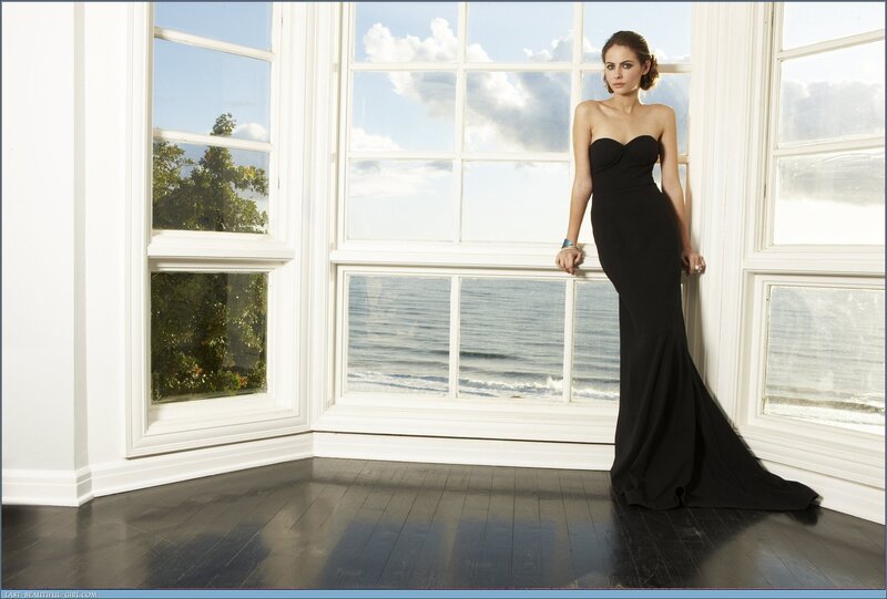 Woman in black gown by window