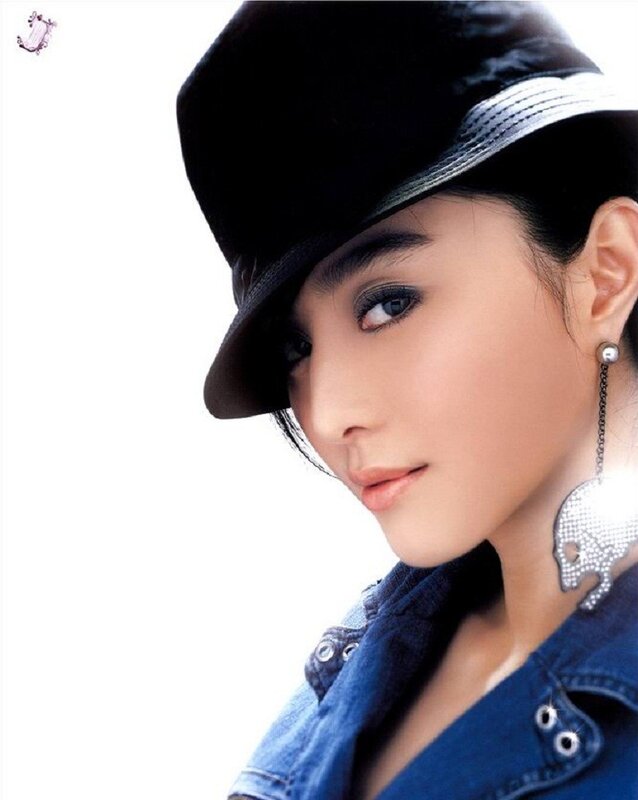 woman in black hat and denim jacket