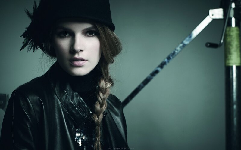 woman in black hat and leather jacket