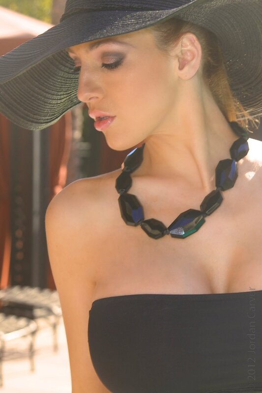 woman in black hat and necklace