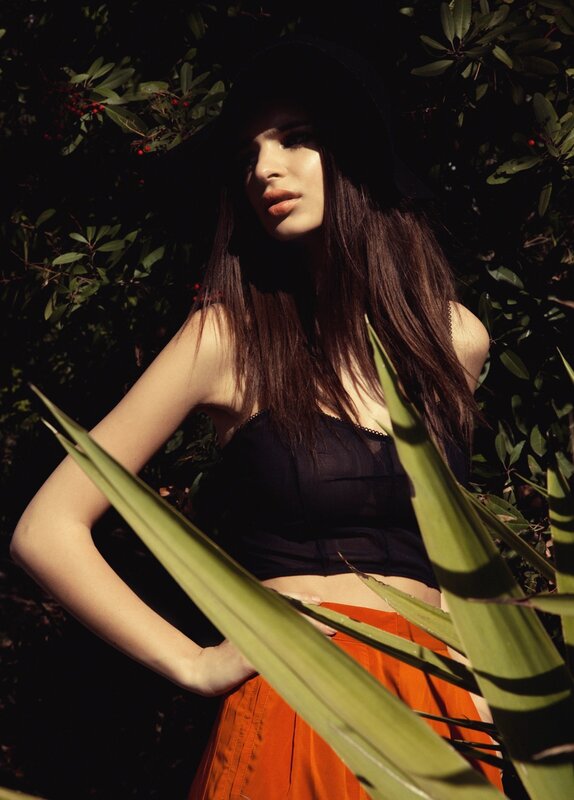 woman in black hat and orange skirt