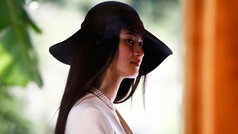woman in black hat and pearls