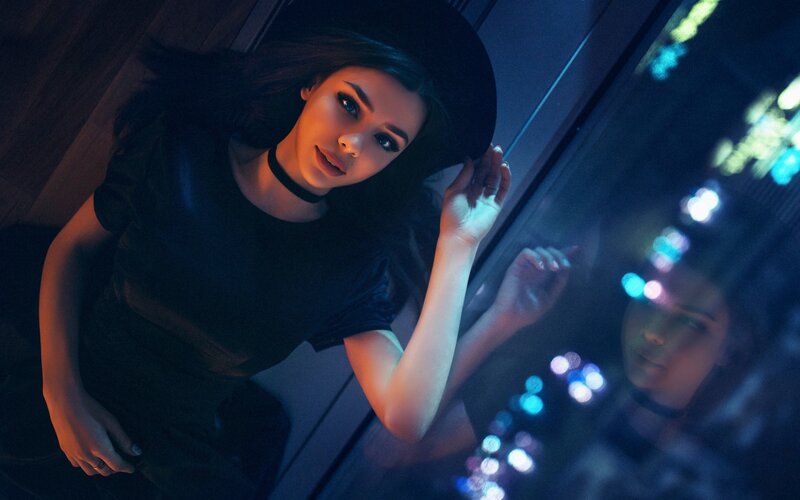 woman in black hat at night