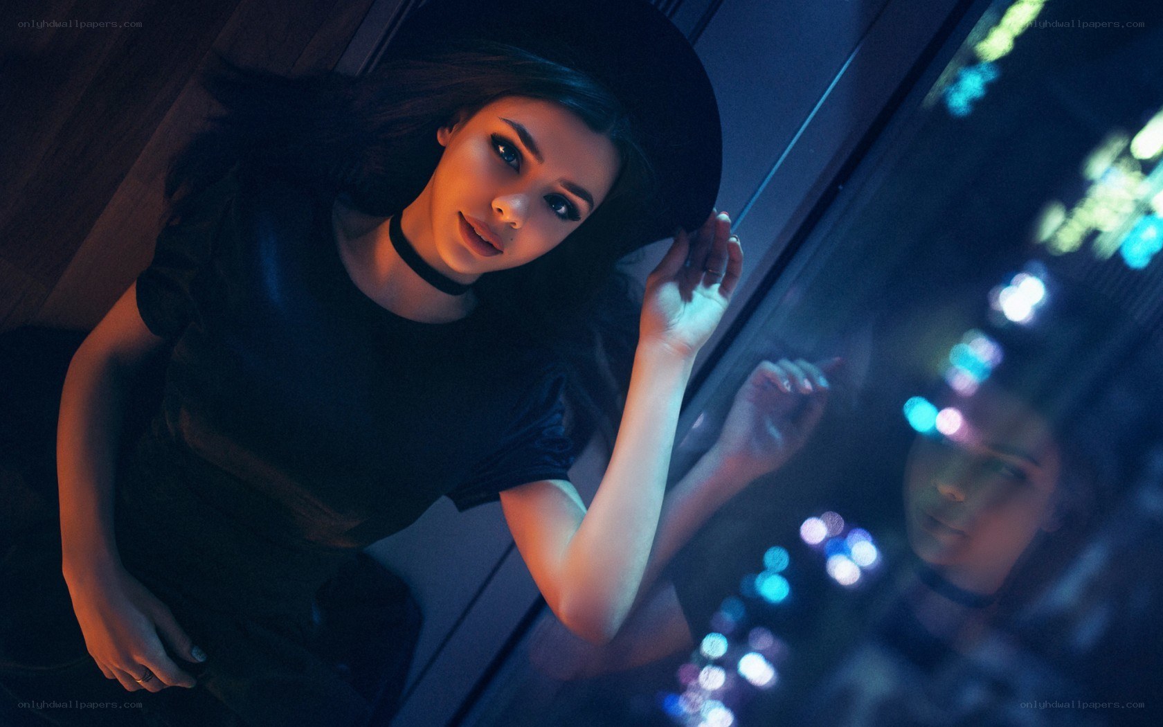 woman in black hat at night