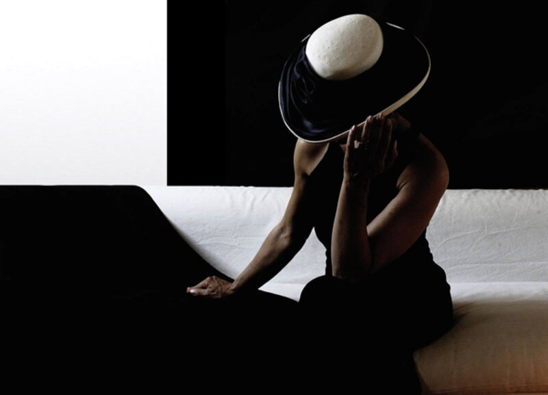 Woman in Black Hat — Dramatic, Photograph, Couch
