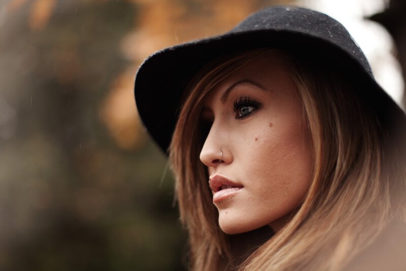 woman in black hat looking away