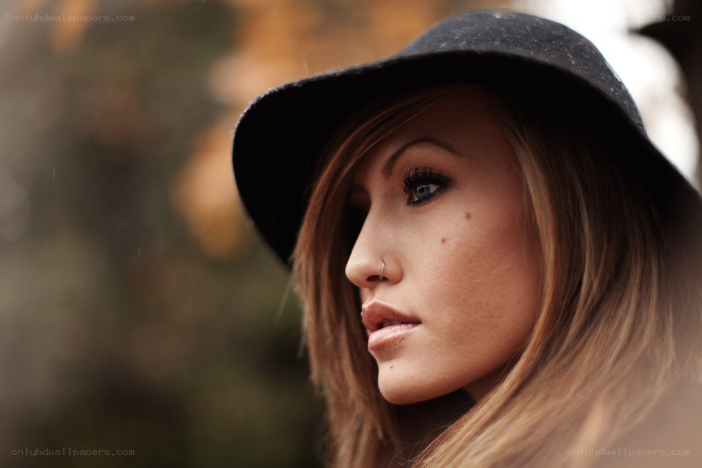 woman in black hat looking away