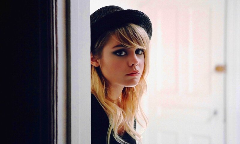 woman in black hat peeking