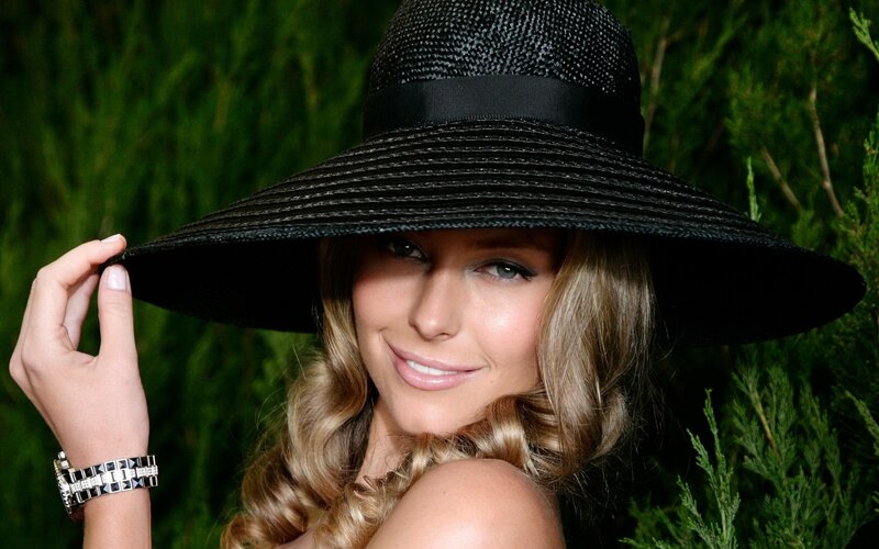 woman in black hat smiling