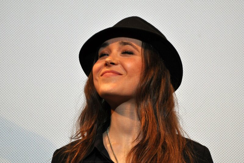 woman in black hat smiling