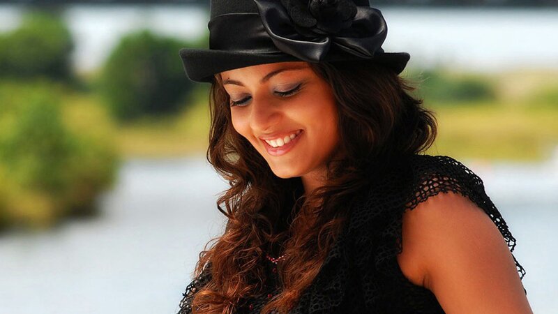 woman in black hat smiling