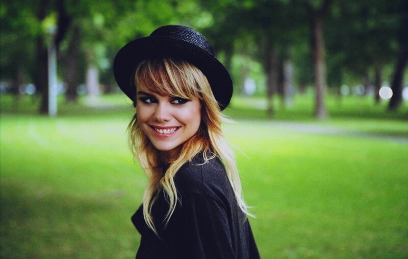 woman in black hat smiling