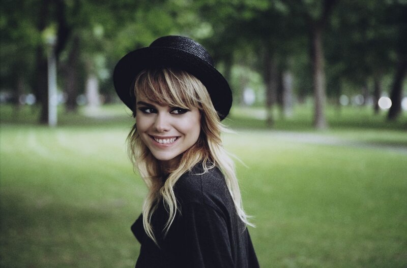 Woman in black hat smiling