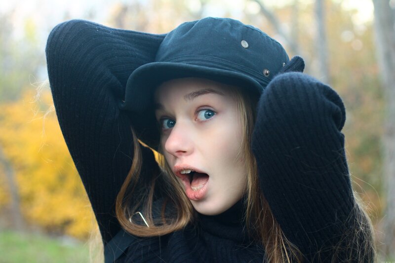woman in black hat surprised