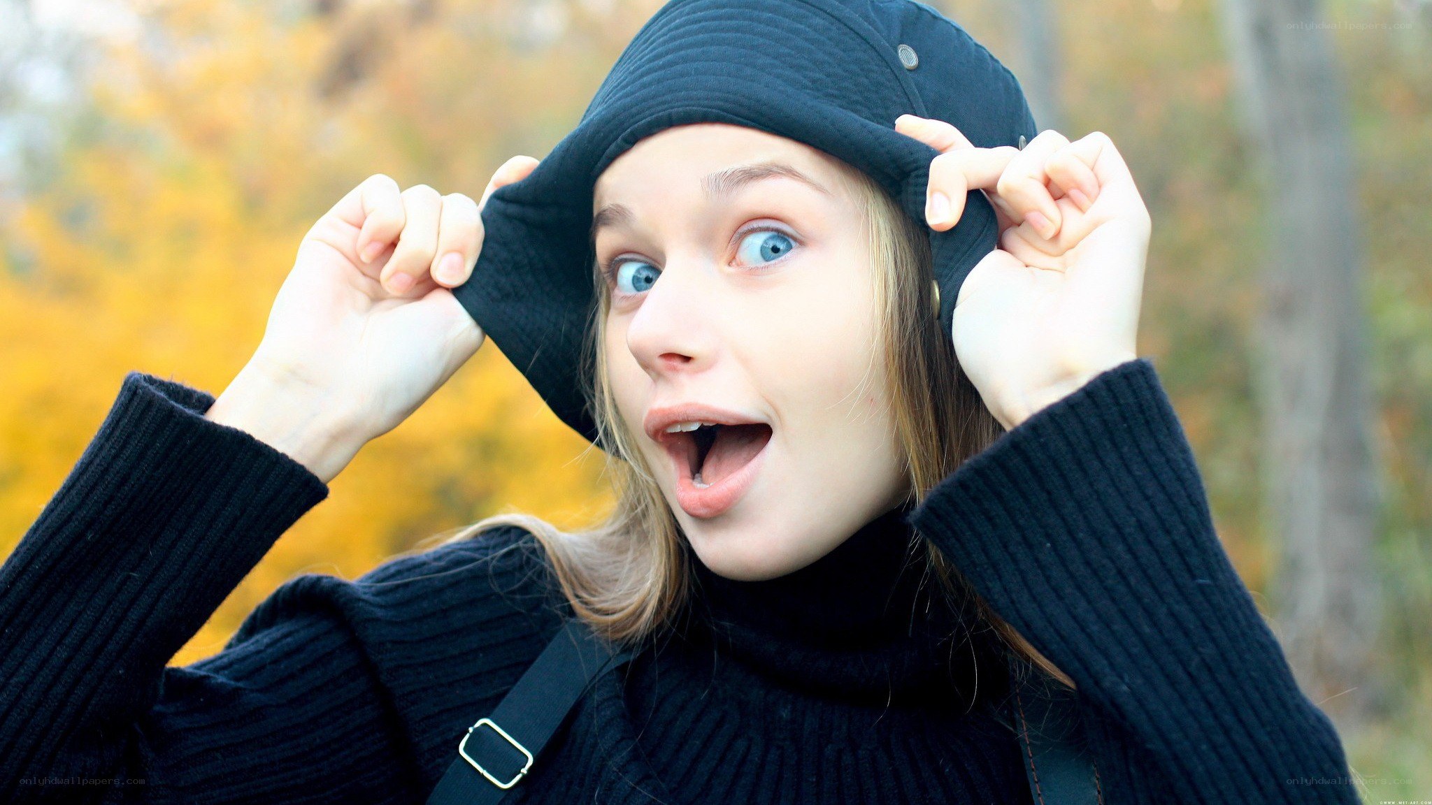 woman in black hat surprised