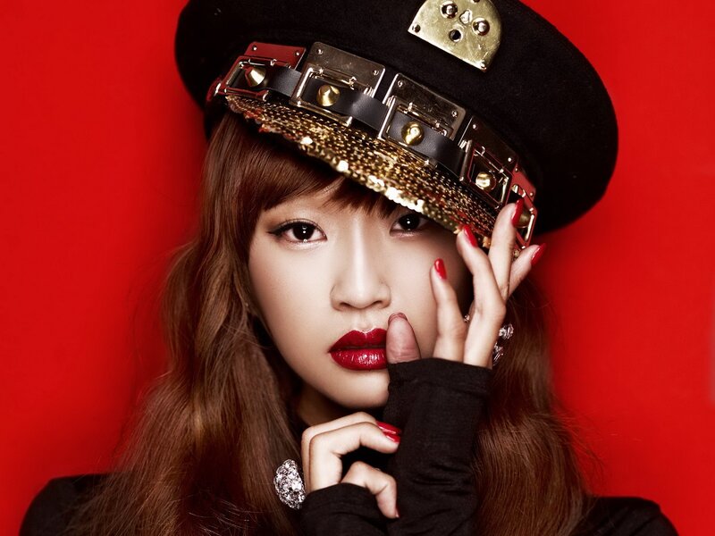 woman in black hat with red background