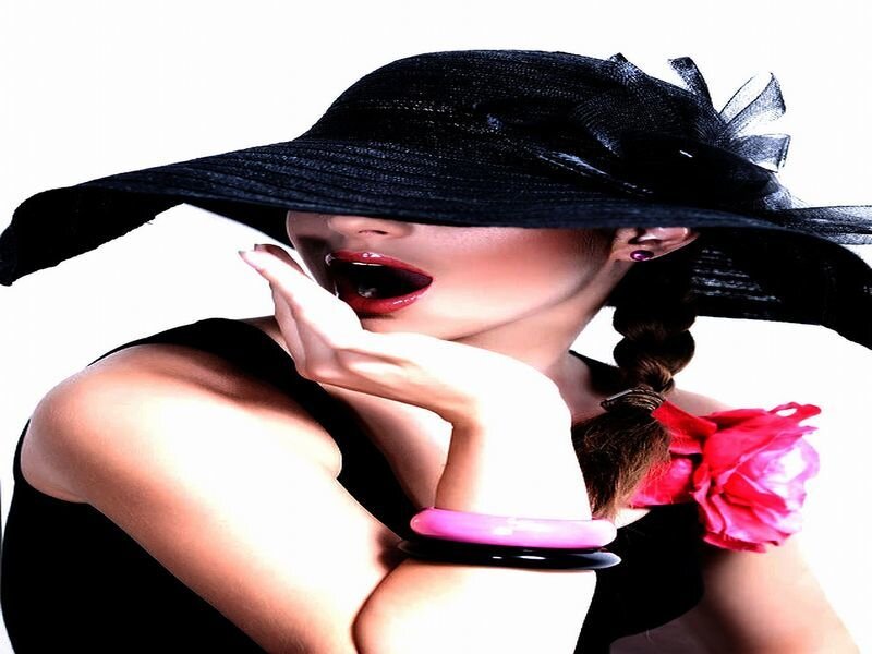 woman in black hat with red flower