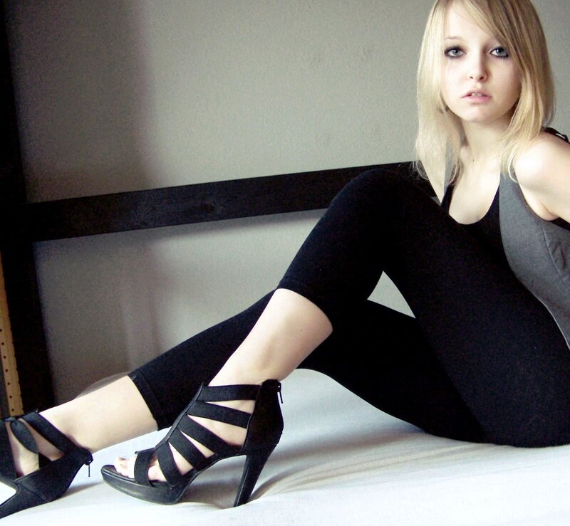 woman in black heels sitting