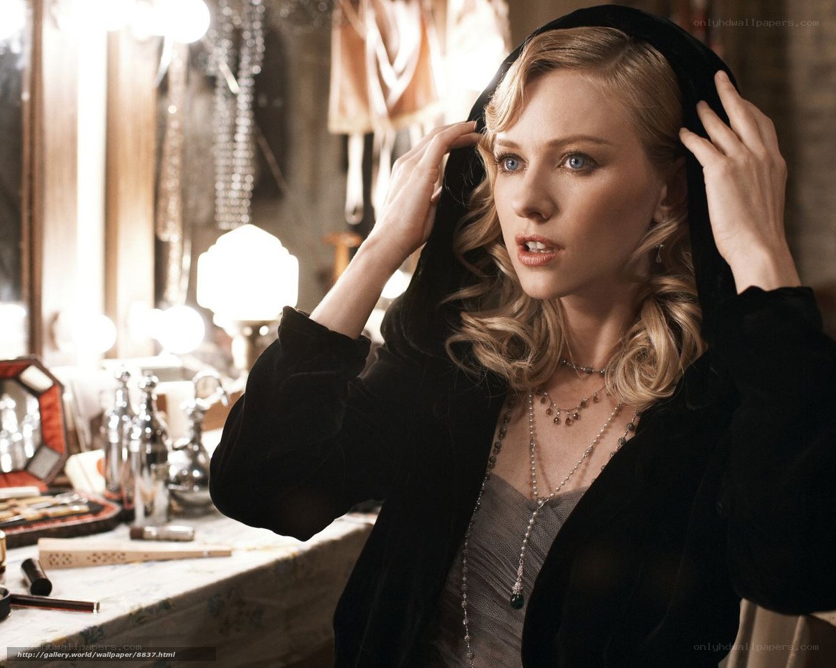 woman in black hood adjusting hair