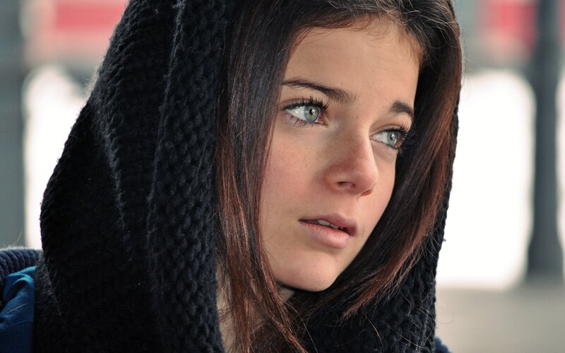 woman in black hood looking away