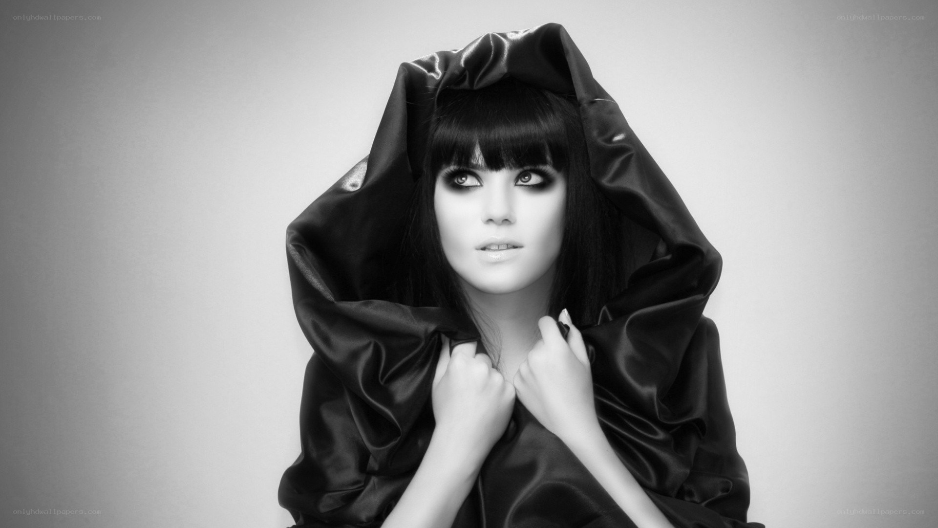 woman in black hooded cloak