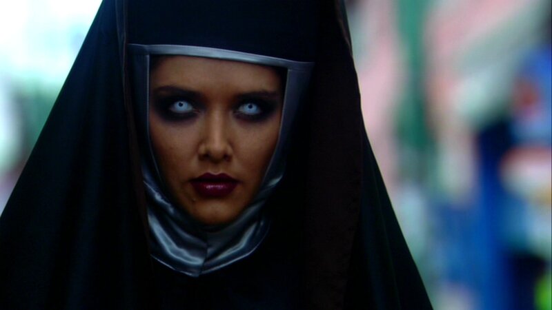 woman in black hooded robe