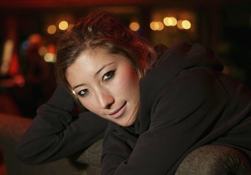 woman in black hoodie looking at camera
