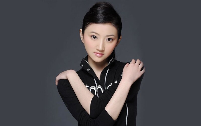 Woman in Black Hoodie — Neutral, Photograph, Dark Background, Arms Crossed