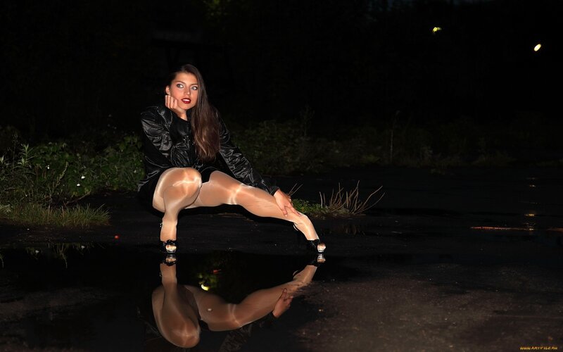 Woman in black jacket at night