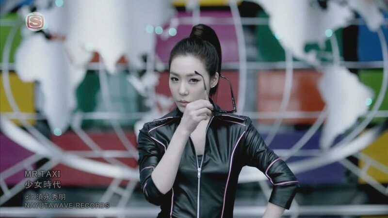 woman in black jacket holding glasses