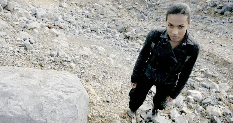 woman in black jacket on rocky terrain