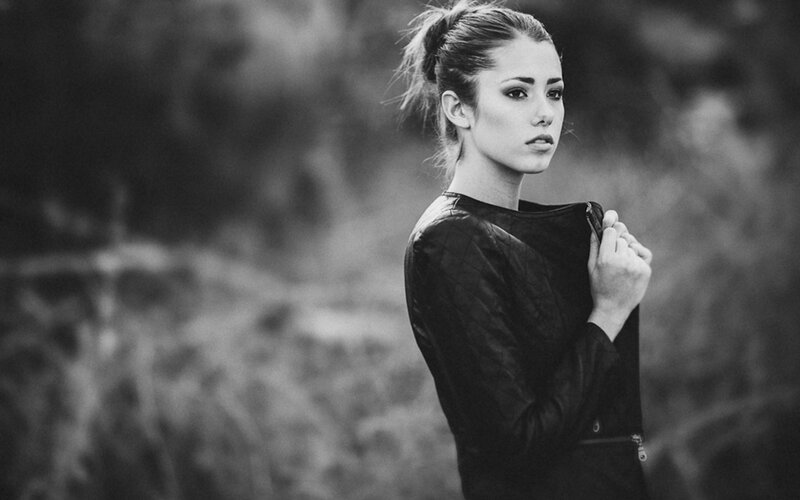Woman in Black Jacket — Serious, Photograph, Hair Bun