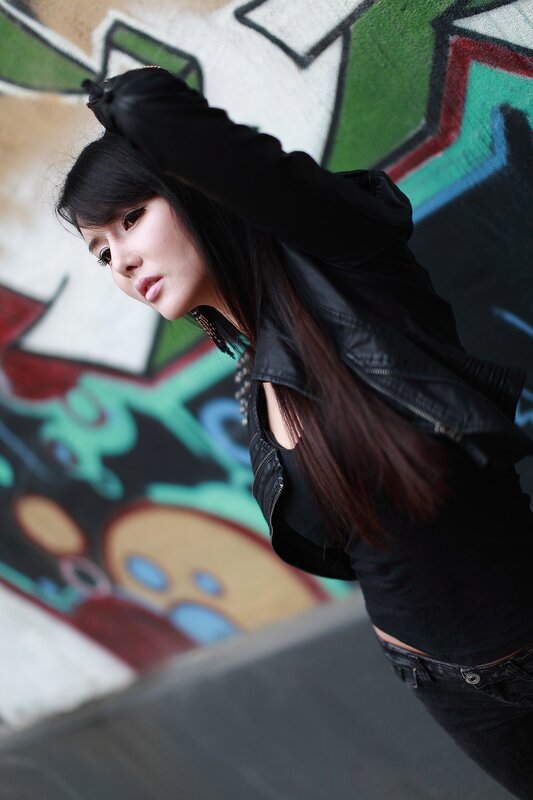 woman in black jacket with graffiti