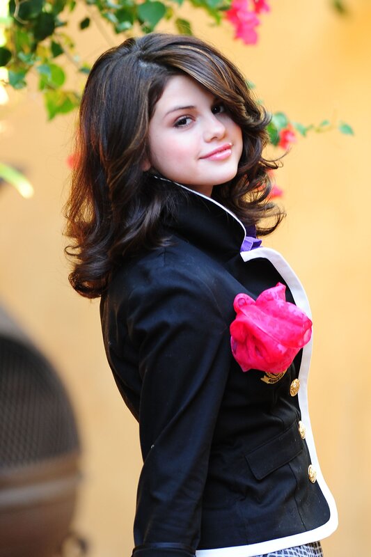 woman in black jacket with pink flower